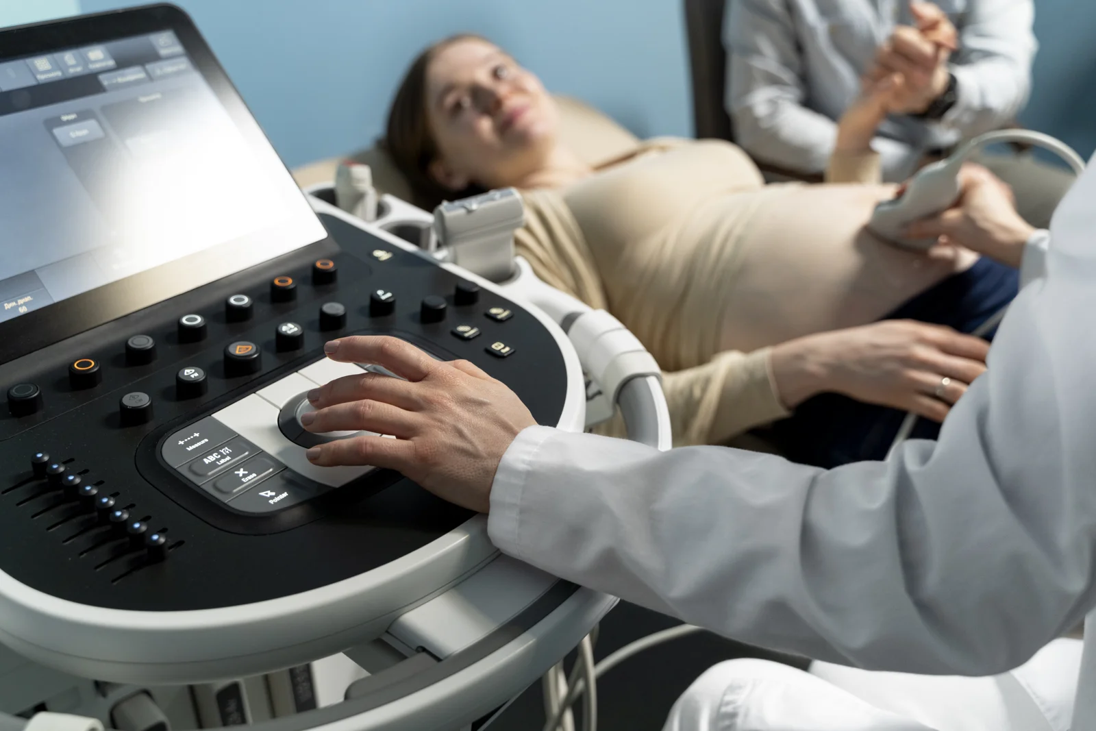 A clinician carrying out a pregnancy ultrasound examination